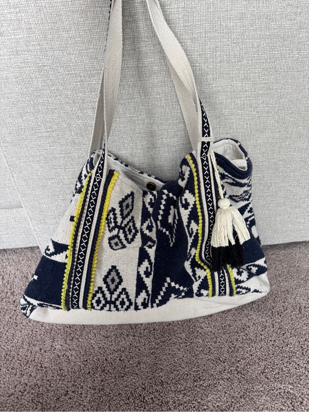 woven tribal pattern with yellow pom-pom trim tote